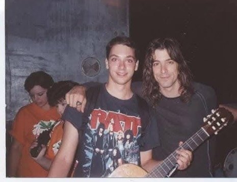 Warren Demartini featured alongside a young fan holding his guitar.