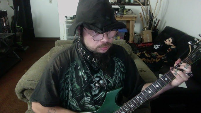 Joshua Saunders, better known as KingCobraJFS playing the guitar.